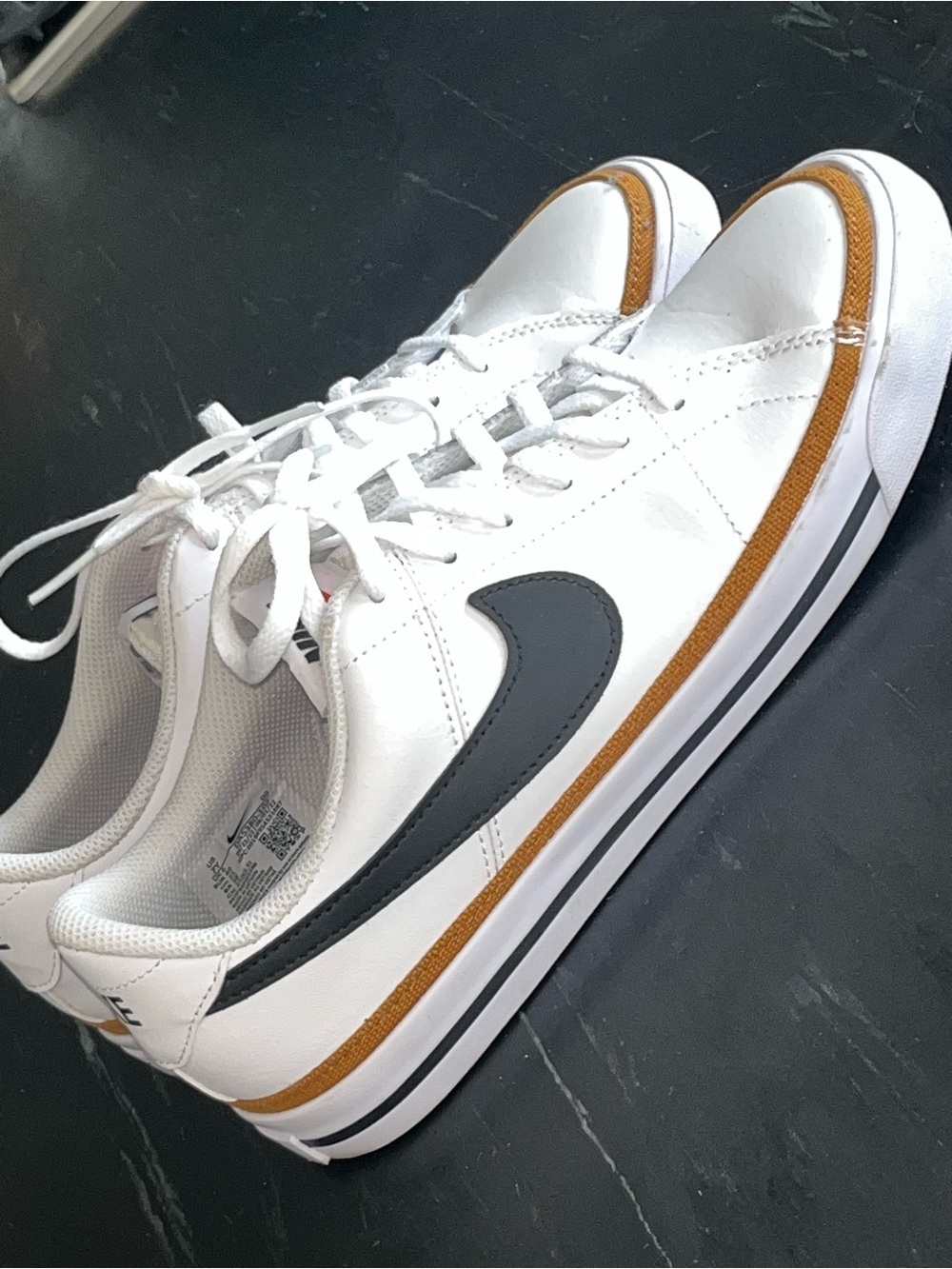 Nike White Sneakers with Black Swoosh and Brown Accent